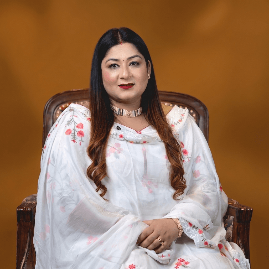 A professional, high-end portrait photograph of Astrologer Komal Kalra. She is dressed elegantly in subtle, warm earthy tones, looking directly at the camera with a calm, authoritative yet welcoming expression. The lighting is soft and…